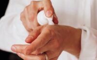 person holding white round ornament