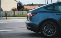 a blue car parked on the side of the road